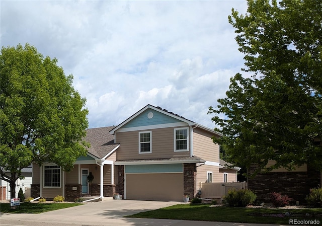 1275 W 50th St, Loveland, CO 80538 - view of front of property with an attached garage, concrete driveway, and a shingled roof