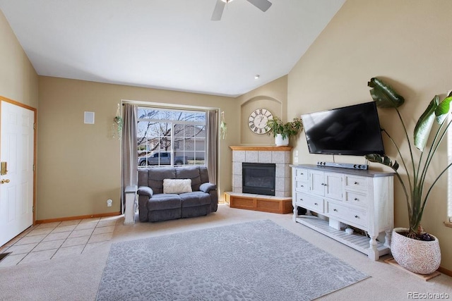 1275 W 50th St, Loveland, CO 80538 - living room with light colored carpet, a tile fireplace, a ceiling fan, baseboards, and lofted ceiling