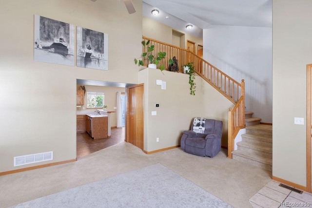 1275 W 50th St, Loveland, CO 80538 - staircase with carpet, baseboards, a high ceiling, and ceiling fan