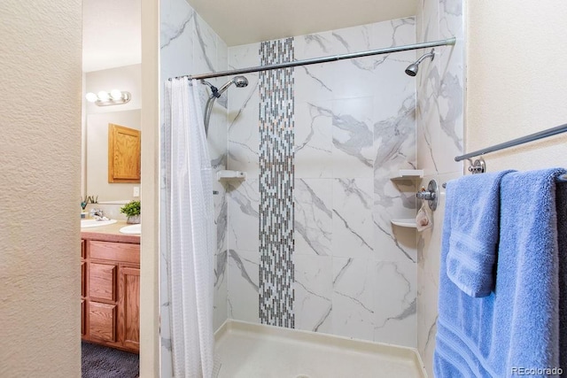 1275 W 50th St, Loveland, CO 80538 - full bathroom featuring a stall shower, vanity, and a textured wall