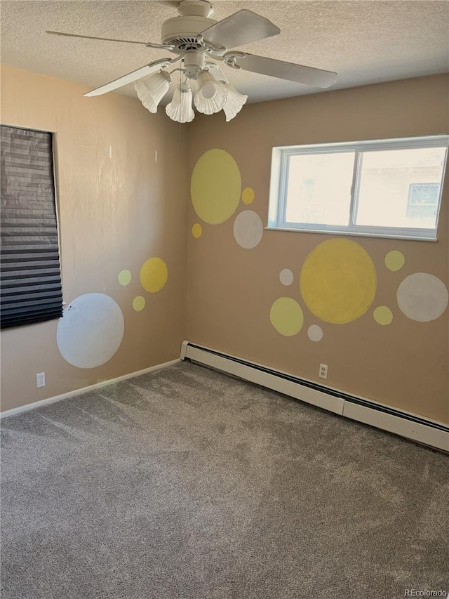 carpeted empty room featuring a baseboard heating unit, ceiling fan, baseboards, and a textured ceiling