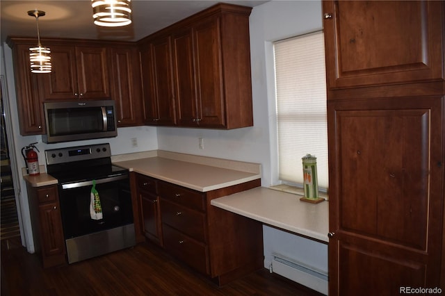 kitchen featuring stainless steel appliances, baseboard heating, pendant lighting, light countertops, and dark wood-type flooring