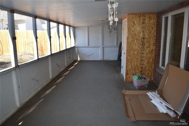 unfurnished sunroom featuring visible vents