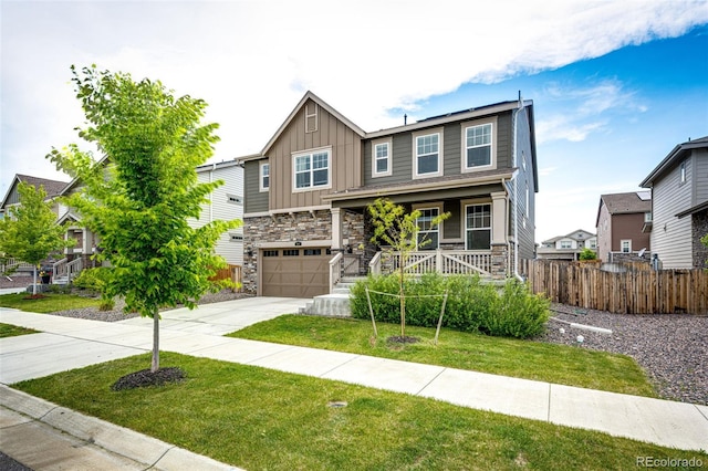 985 S Elk Way, Aurora, CO 80018 - craftsman-style home featuring board and batten siding, concrete driveway, stone siding, covered porch, and an attached garage