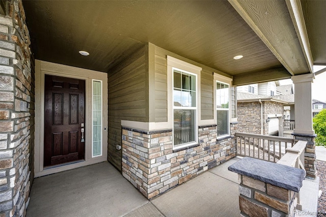 985 S Elk Way, Aurora, CO 80018 - doorway to property with a porch and stone siding