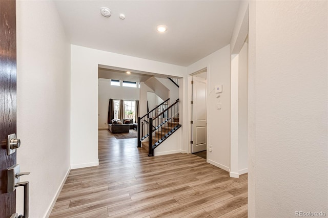 985 S Elk Way, Aurora, CO 80018 - hall featuring stairway, light wood finished floors, and recessed lighting