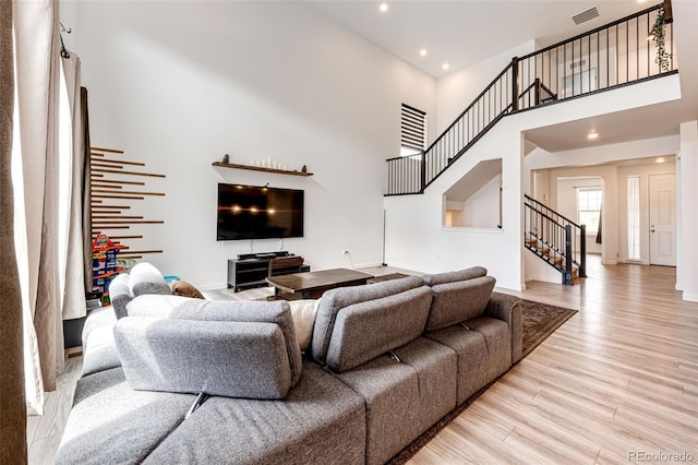 985 S Elk Way, Aurora, CO 80018 - living room with stairway, a towering ceiling, light wood-type flooring, and recessed lighting