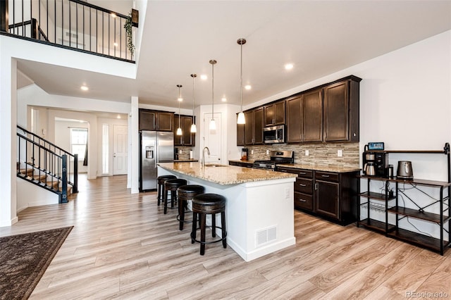 985 S Elk Way, Aurora, CO 80018 - kitchen featuring stainless steel appliances, light wood-style floors, dark brown cabinets, and recessed lighting