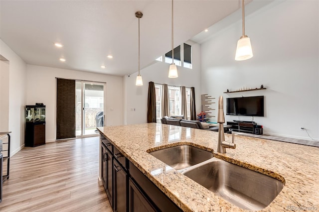 985 S Elk Way, Aurora, CO 80018 - kitchen featuring open floor plan, decorative light fixtures, light wood-type flooring, recessed lighting, and light stone countertops