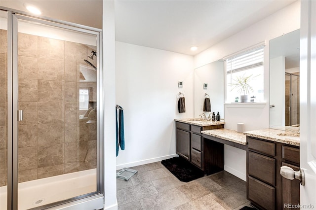 985 S Elk Way, Aurora, CO 80018 - bathroom with vanity, a stall shower, and healthy amount of natural light