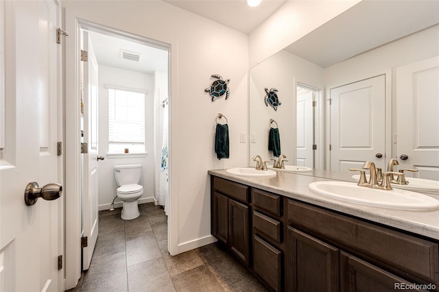 985 S Elk Way, Aurora, CO 80018 - bathroom with double vanity and tile patterned flooring