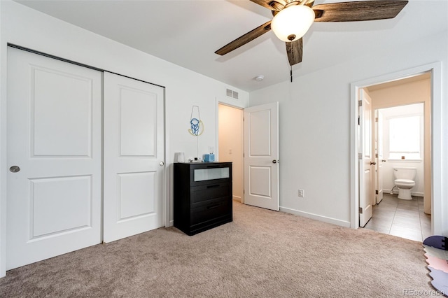 985 S Elk Way, Aurora, CO 80018 - bedroom with light colored carpet, a closet, ensuite bathroom, and ceiling fan