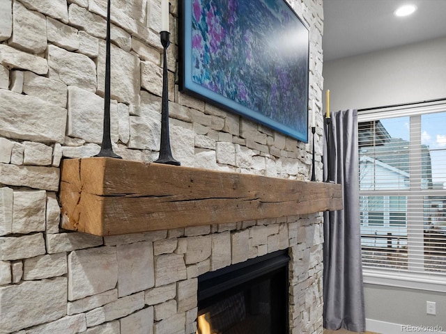 9035 S Shawnee Ct, Aurora, CO 80016 - detailed view of baseboards, a stone fireplace, and recessed lighting