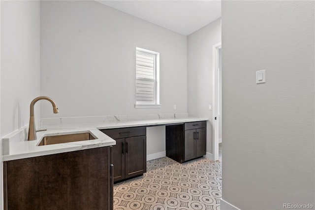 kitchen featuring dark brown cabinetry and sink