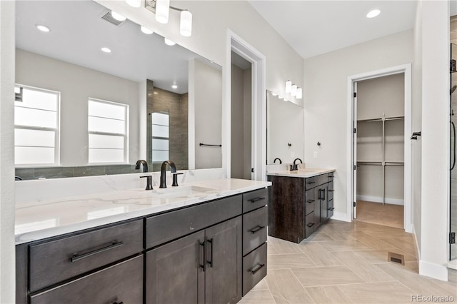 bathroom with walk in shower and vanity