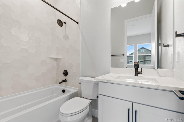 full bathroom with tiled shower / bath, vanity, and toilet