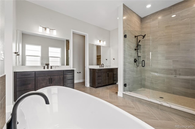 bathroom with vanity and independent shower and bath