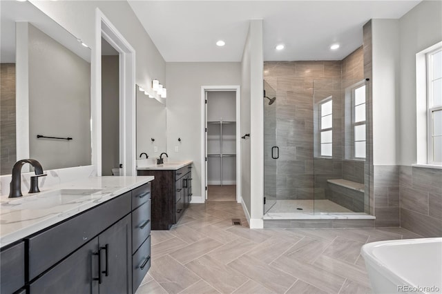 bathroom featuring vanity and shower with separate bathtub