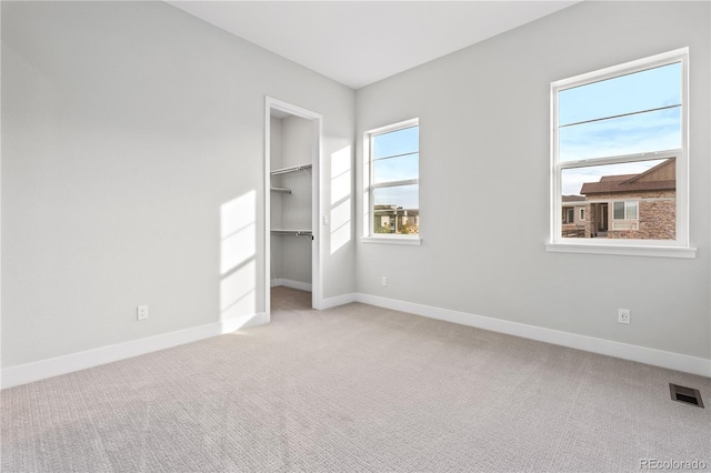 unfurnished room featuring light colored carpet