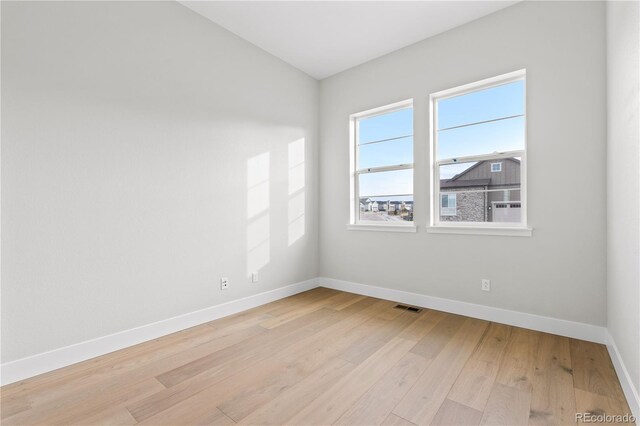 spare room featuring light hardwood / wood-style flooring