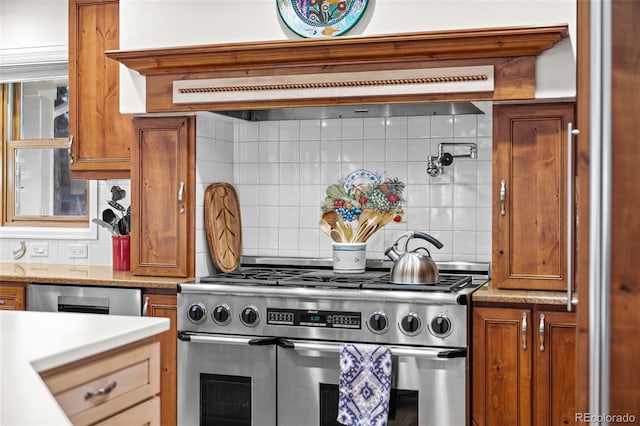 kitchen with dishwashing machine, double oven range, decorative backsplash, and ventilation hood