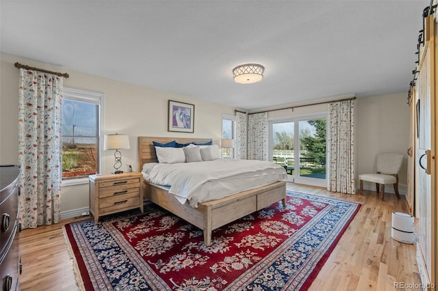 bedroom featuring light hardwood / wood-style flooring and access to outside