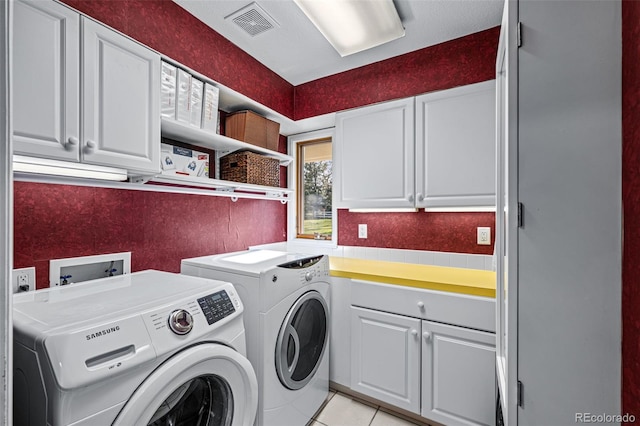 washroom with cabinets, light tile patterned floors, and independent washer and dryer