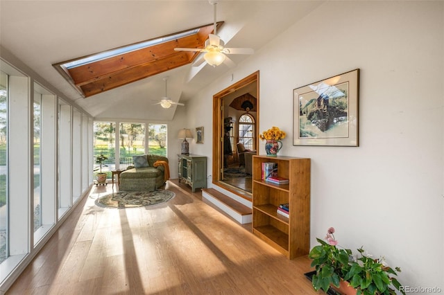 sunroom featuring lofted ceiling and ceiling fan