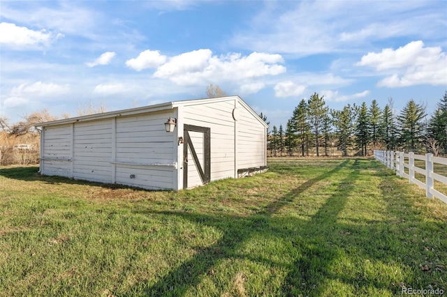 view of outbuilding with a yard