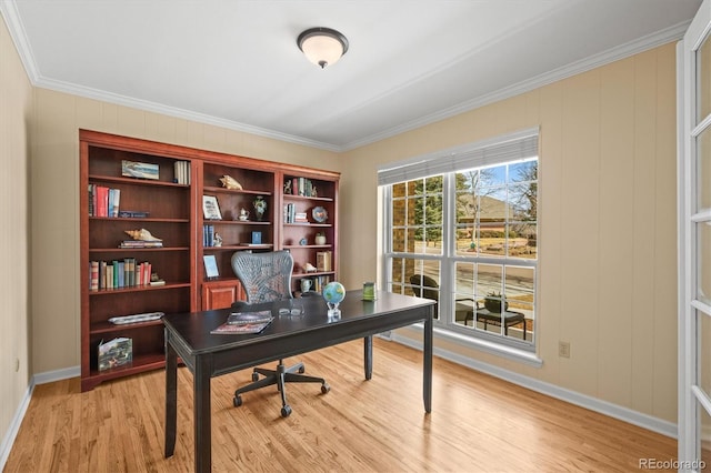 office area featuring baseboards, light wood-style flooring, and crown molding