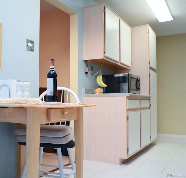 kitchen featuring a textured ceiling and a breakfast bar area