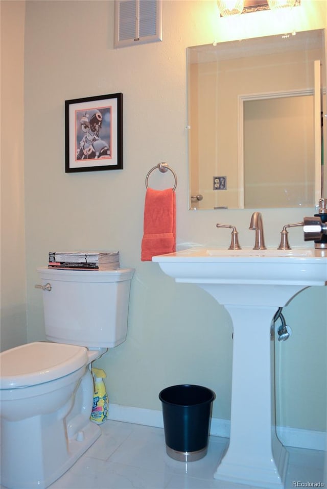 bathroom featuring toilet and tile patterned floors