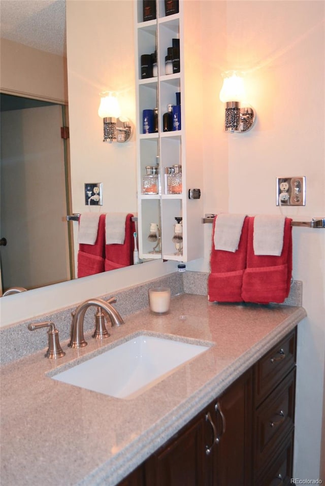 bathroom featuring a textured ceiling and vanity