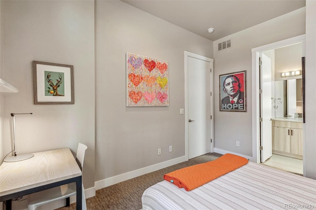 bedroom featuring baseboards, visible vents, ensuite bathroom, and carpet