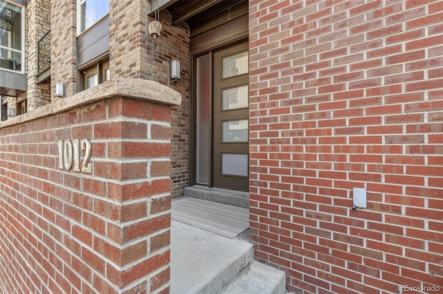 property entrance with brick siding