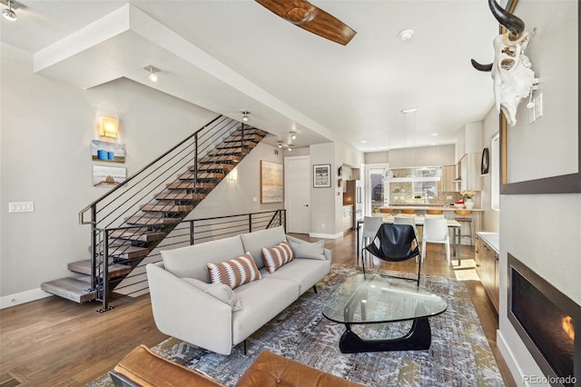 1012 Bannock St, Denver, CO 80204 - living room with wood finished floors, stairs, and baseboards