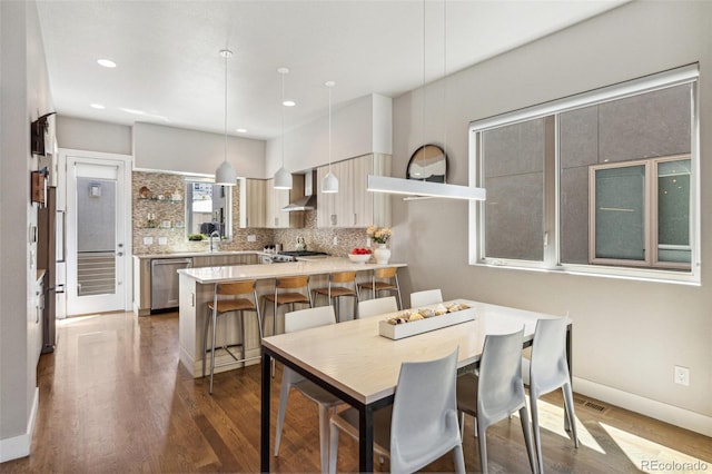 1012 Bannock St, Denver, CO 80204 - dining room featuring dark wood-type flooring, recessed lighting, and baseboards