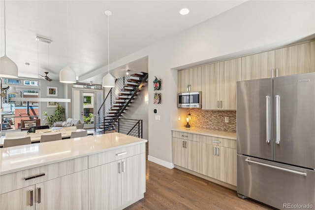 1012 Bannock St, Denver, CO 80204 - kitchen with appliances with stainless steel finishes, light countertops, decorative backsplash, wood finished floors, and open floor plan