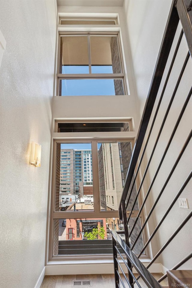 1012 Bannock St, Denver, CO 80204 - staircase with a textured wall, baseboards, and a high ceiling