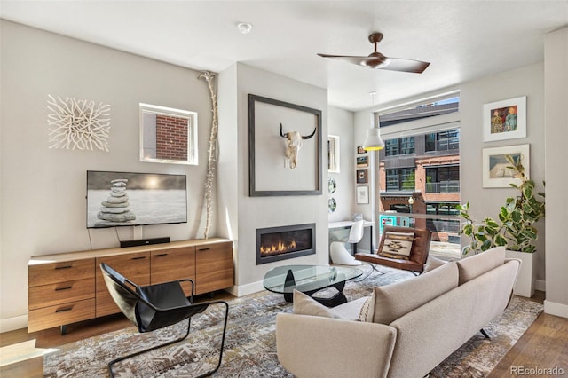 1012 Bannock St, Denver, CO 80204 - living area with wood finished floors, baseboards, a glass covered fireplace, and a ceiling fan