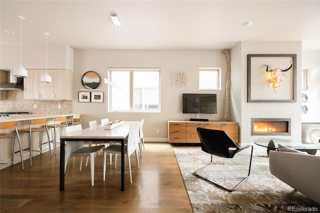 1012 Bannock St, Denver, CO 80204 - dining room with wood finished floors, a warm lit fireplace, and baseboards