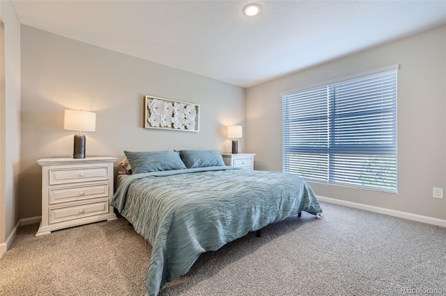 carpeted bedroom with multiple windows