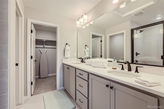 bathroom with an enclosed shower and vanity