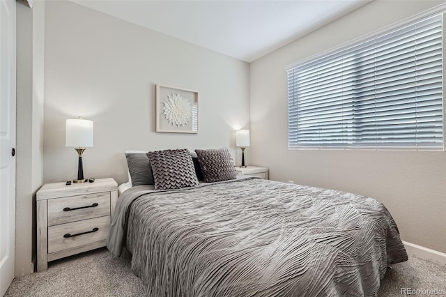 bedroom featuring light colored carpet