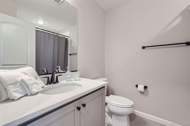 bathroom featuring toilet, vanity, tile patterned flooring, and curtained shower