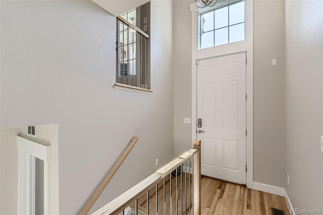 3411 N Xenia St, Denver, CO 80238 - foyer entrance featuring light wood finished floors and a chandelier