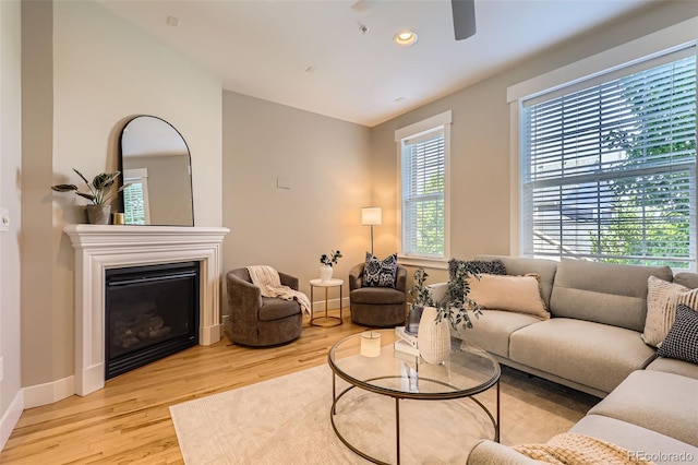 3411 N Xenia St, Denver, CO 80238 - living room with wood finished floors, ceiling fan, a glass covered fireplace, and recessed lighting