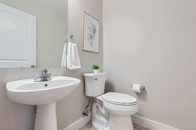 3411 N Xenia St, Denver, CO 80238 - half bathroom with baseboards and tile patterned flooring