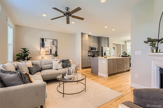 3411 N Xenia St, Denver, CO 80238 - living room with recessed lighting, a ceiling fan, and light wood finished floors