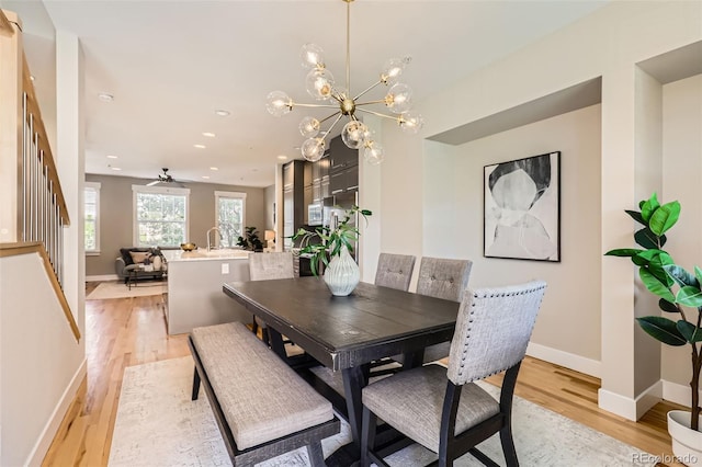 3411 N Xenia St, Denver, CO 80238 - dining room featuring light wood finished floors, stairs, a chandelier, recessed lighting, and a ceiling fan